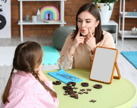 Fonoaudióloga infantil realizando terapia com criança com TPAC em consultório.