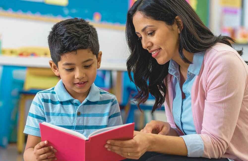Criança em atividade de leitura e escrita relacionada ao desenvolvimento da linguagem.